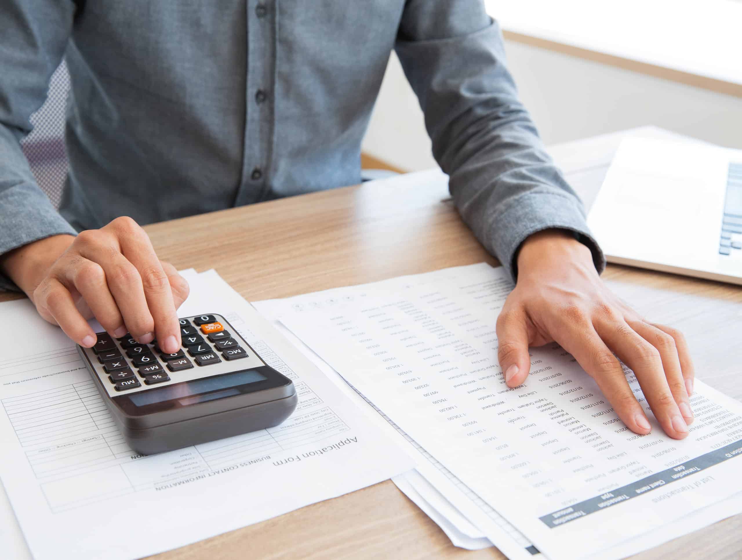 Accountant calculating income and examining report